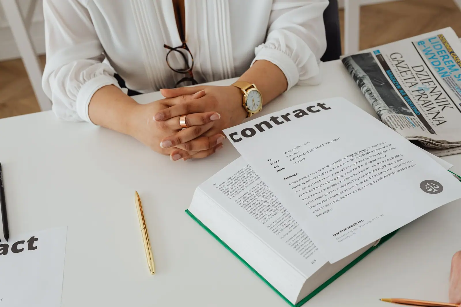 An open contract and a pen on a desk